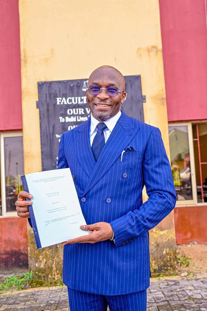 Rt. Hon. Kalu proudly displays his PhD thesis after his successful defence