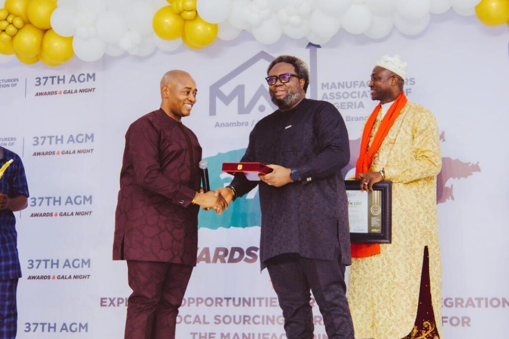 The Deputy Governor of Enugu State, Barr. Ifeanyi Ossai, presenting an award of excellence to Prof. Ike-Muonso at the 37th MAN AGM