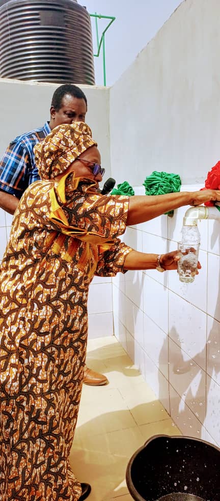 Pastor (Mrs.) Esther Odeyemi testing the borehole water while the Pastor in charge of FCT Province 6, Pastor Adekunle Lawal watches
